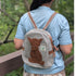 Person wearing a hemp bag with a cat design outdoors