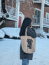 a woman carrying a tote bag