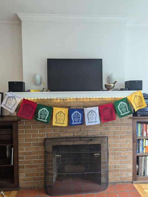 Hanging Rinpochhe Prayer Flag On Fireplace